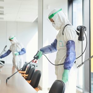 Workers Disinfecting Conference Room